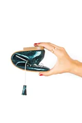 Zapato tipo blucher con diseño híbrido de bailarina, confeccionado en piel azul con textura de reptil. Presenta cierre con cordones y borlas de piel, con una banda elástica en la parte trasera para un ajuste óptimo. Cuenta con suela de cuero y acabado artesanal.