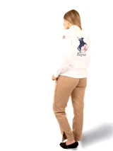 Camisa de manga larga color rosado, confeccionada en algodón. Presenta un corte entallado, cuello clásico y puños abotonados. En la espalda destaca un bordado grande con la silueta de un jinete y la inscripción 'Bagual', además de un parche con la bandera de Uruguay en la manga.