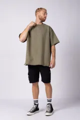 Remeron de algodón rústico con efecto de lavado gastado, corte oversize, cuello redondo y mangas cortas con terminaciones al corte.