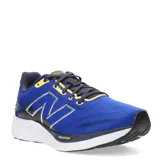 Championes de running New Balance, color azul con detalles en amarillo, azul marino y blanco. Presentan tecnología Fresh Foam en la entresuela, logo N lateral en plateado y suela de goma negra.