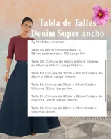 Jean de tiro alto con corte elefante, caracterizado por su silueta amplia y acampanada en las piernas. Confeccionado en denim de color azul oscuro con costuras a contratono.