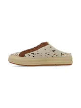 Zuecos estilo champión destalonados, con diseño estampado tipo animal print de vaca en tonos blanco, marrón y negro, pasadores marrones y suela de plataforma en tono tostado.