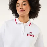 Buzo blanco de estilo polo con cuello abotonado, manga larga y puños con detalle de línea roja. Presenta un bordado pequeño de Minnie Mouse en el pecho.