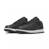 Championes Air Jordan 1 Low SE en color negro, con detalles de textura tipo elephant print en el swoosh y el talón. Presenta una suela blanca contrastante y el logo de Jordan en el talón.