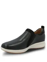 Zapatillas slip on Hush Puppies modelo Spinal Slip On, color negro, confeccionadas en cuero con detalles de gamuza y cierre lateral decorativo. Poseen suela blanca y base de goma con tecnología TripleDensity para mayor amortiguación y soporte.