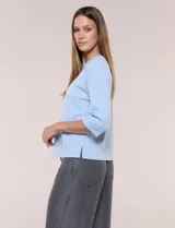 Buzo de calce relajado color negro, confeccionado en modal con cuello redondo clásico, mangas tres cuartos de hombros caídos con puño y ruedo recto.