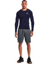 Remera térmica deportiva Under Armour HeatGear Armour Compression de manga larga y calce ajustado, color azul marino, con cuello redondo y el logo de la marca estampado en el pecho en color blanco.