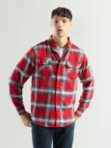 Camisa de franela a cuadros color celeste, gris y negro, de manga larga con dos bolsillos frontales con solapa abotonada.