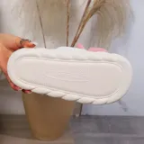 Pantuflas abiertas sin talón con diseño de chanchito, confeccionadas en material sintético suave, con suela de goma antideslizante.
