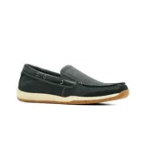 Mocasín de cuero negro estilo náutico, con costuras pespunteadas visibles, cordón decorativo lateral que pasa por ojalillos metálicos, suela de goma blanca y base caramelo con estriado antideslizante.