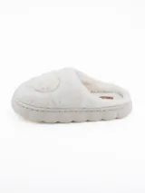 Pantuflas de peluche color blanco con diseño de corazón en relieve en la parte superior y suela de plataforma acolchada.