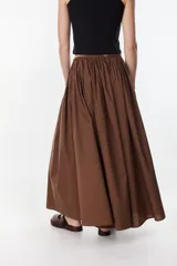 Pantalón largo color marrón, estilo wide leg, de tiro medio con cintura elástica fruncida y bolsillos laterales.