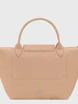 Cartera de mano modelo Le Pliage One tamaño S, confeccionada en nylon negro con detalles en cuero. Presenta cierre superior con solapa y botón a presión característico de la marca.