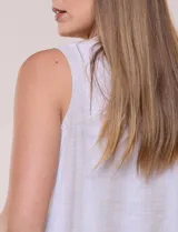 Blusa sin mangas de algodón liviano con diseño de rayas verticales en tonos beige y blanco, escote redondo, abotonadura frontal con botones rústicos y detalle de nudo para anudar en la cintura.