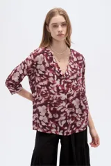 Blusa de viscosa bordó con estampado abstracto, escote en V con cuello tipo solapa y mangas 3/4, de corte holgado.