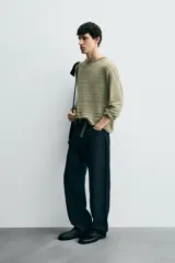 Jersey relaxed fit de punto ligero color verde claro, con rayas horizontales en un tono más claro. Tiene cuello redondo amplio, manga larga y acabados en rib.