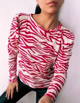 Remera de manga larga con cuello redondo y estampado de cebra en colores verde, rojo, azul y marrón.