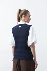 Chaleco tejido de algodón en color marrón, con diseño de textura acanalada y corte recto.