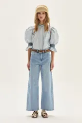 Blusa de algodón a cuadros en tonos celestes y beige, con mangas abullonadas, cuello alto y detalles de punto smock en cuello y puños.