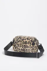 Bolso bandolera Bimba y Lola de tamaño pequeño, confeccionado en nylon con estampado animal print. Presenta estructura blanda, asa regulable de tejido negro, cierre principal con cremallera y bolsillos laterales con cierre.