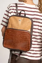 Mochila marrón con estampado de piel de cocodrilo, con cierre superior y bolsillo frontal con cierre.