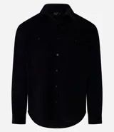 Camisa de hombre color verde oscuro, confeccionada en terciopelo, con cuello clásico, manga larga y dos bolsillos frontales con solapa y botón. Cierre frontal con botones.