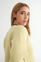 Cardigan negro de tejido de punto, con escote en V, manga larga y cierre frontal con tres botones dorados grandes.