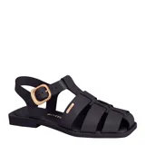 Sandalias franciscanas de cuero negro para mujer, con diseño de tiras cruzadas, hebilla metálica dorada de ajuste en el lateral y suela plana.