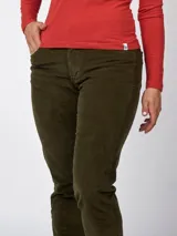 Pantalón de pana azul marino, de corte recto y calce ajustado, con cinco bolsillos y cinturón de cuero marrón.