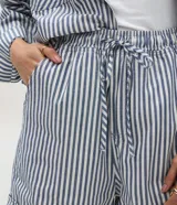 Short tipo runner de jean de algodón, con diseño de rayas verticales en azul y blanco, cintura elástica con cordón de ajuste, bolsillos laterales y dobladillo en la terminación.