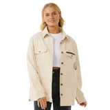 Campera color beige de corte recto, con cuello camisero, cierre frontal con botones a presión y bolsillos con solapa en el pecho. Presenta bordados decorativos en el frente y la espalda.