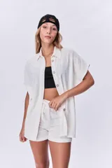 Camisola color arena de mangas cortas con botones.