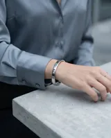 Esclava rígida de acero inoxidable con acabado pulido brillante y diseño minimalista.