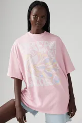 Remera rosa de corte holgado con estampado de texto e imagen abstracta en el frente.