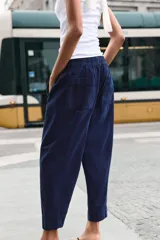 Pantalón de tiro bajo con cintura elástica ajustable mediante cordón, bolsillos delanteros y bolsillos de plastrón en la parte trasera.