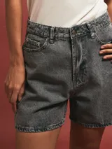 Short de denim gris claro, tiro alto, con bolsillos delanteros y traseros.