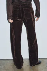 Jeans de tiro alto con corte balloon leg y largo completo. Presentan diseño de cinco bolsillos, trabillas en la cintura y cierre frontal con cremallera y botón. Confeccionados en tejido flocado con textura aterciopelada.