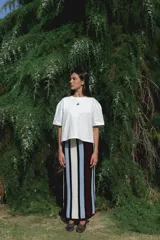 Falda larga tejida a rayas verticales en tonos azul, blanco, negro y bordó, con cintura elástica.