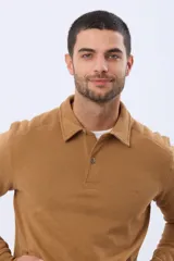 Buzo tipo polo de felpa color tostado, con cuello camisero, cierre frontal de botones y bolsillos laterales.
