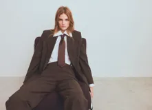 Blazer de corte sastre con diseño de doble botonadura, confeccionado en tejido con patrón de cuadros sutiles. Presenta solapas clásicas, bolsillos con solapa y una estructura entallada que aporta un estilo formal y sofisticado.