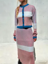 Falda midi de punto acanalado con diseño a rayas verticales en tonos rosado, bordó y celeste. Presenta un corte ajustado tipo lápiz y cintura elástica de tiro alto.