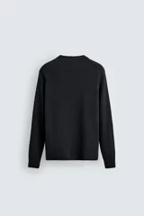 Jersey de punto con lana, de corte relajado, cuello redondo y manga larga ranglán con acabados en rib.