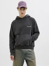 Canguro negro con capucha, de corte holgado y mangas raglán. Presenta un gran estampado en color beige en la espalda con la inscripción "Studio Originals" y texto descriptivo, además de puños y dobladillo acanalados.