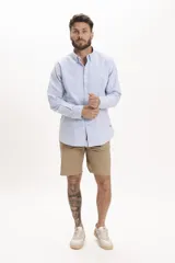 Camisa celeste de manga larga con cuello abotonado y corte clásico.