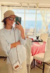 Camisa de corte clásico con estampado de rayas verticales en color celeste y blanco, cuello camisero y cierre frontal con botones.