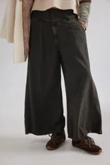 Pantalón de jean con corte wide leg, tiro medio-bajo y diseño de pinzas frontales. Presenta una pretina ancha con cierre de botones y bolsillos delanteros funcionales.