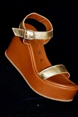 Sandalias de cuero color marrón chocolate con plataforma y taco corrido. Tira ancha sobre los dedos y tira al tobillo con hebilla dorada.