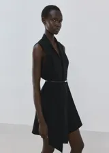 Vestido corto negro sin mangas, con cuello en V, diseño recto, bajo asimétrico y un fino cinturón incluido.