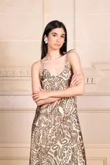 Vestido largo tipo solera con breteles finos y escote en V, estampado en tonos verde militar y rosado pálido con diseño batik/floral.