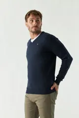 Sweater de punto color rosa con cuello en V y logo bordado en el pecho.